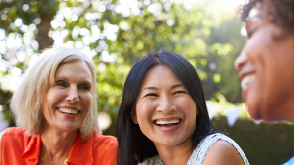 Women smiling outside Mullins SC dental implant dentist